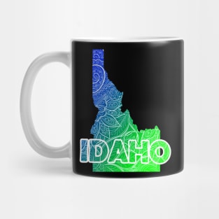 Colorful mandala art map of Idaho with text in blue and green Mug